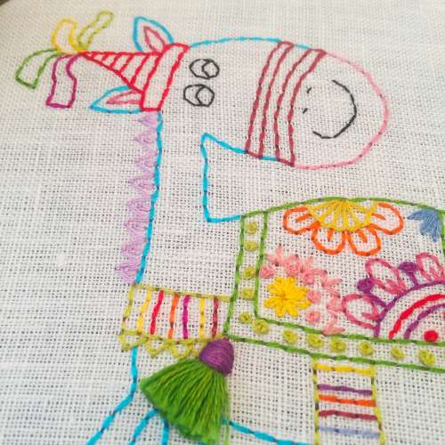 how to embroider back stitch: Details of hand embroidered horse - colorful threads on white linen: BackStitch Embroidery tutorial example image; back stitch hand embroidery; back stitch tutorial; back stitch embroidery tutorial